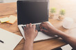 © Prostock-studio - African-american businessman in office type on laptop