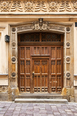 Old shabby door with metal door handle. Krakow, Poland