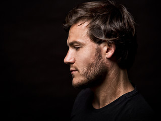 caucasian man wearing  black tshirt and trendy hairstyle