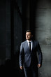 © Gennady Danilkin - Portrait of stylish male dressed in a suit over grey background