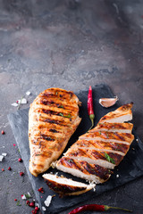 Wall Mural - Grilled chicken fillets on slate plate.