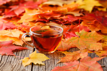 Wall Mural - fall background with maple leaves on wood table