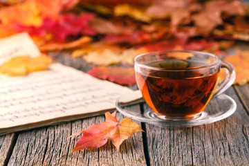 Wall Mural - relax time in fall season. red maple leaf on table