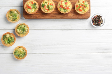 Wall Mural - Composition with broccoli quiche tartlets on table