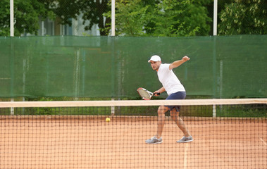 Sticker - Young man playing tennis on court