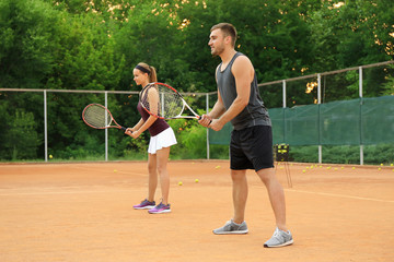 Sticker - Young man and woman playing tennis on court