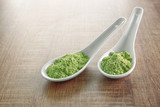 Fototapeta Lawenda - Spoons with wheat grass powder on wooden table