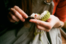 Close Up Shot Of Woman's Hands Knitting With A Crochet
