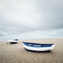 Two Wooden Boats On A Beach
