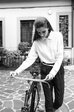 Fashionable Woman Holding A Vintage Bicycle