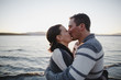 © Rob and Julia Campbell/Stocksy - Young happy couple enjoying being together at the beach at sunset