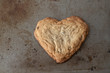 © Sherry Heck/Stocksy - Heart shaped cookie on naturally distressed metal baking sheet