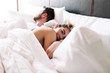 © Kayla Snell/Stocksy - Couple in bed