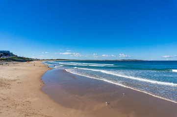 Beach landscape with sand shore and blue water