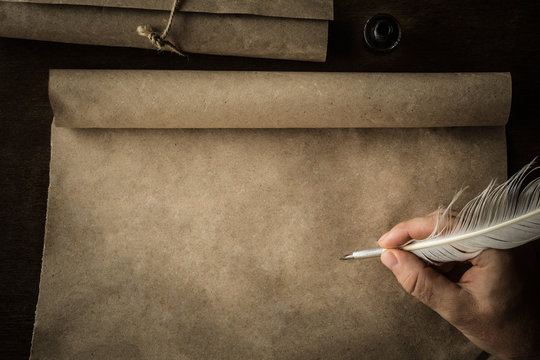 Hand writing with old quill pen on the old paper. Historical atmosphere. Empty place for a text.