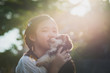 Beautiful asian girl playing with siberian husky puppy in the park