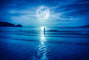 Super moon. Colorful blue sky with cloud and bright full moon over seascape.