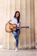 © guerrieroale - Woman playing Guitar at Ancient Temple
