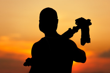 Wall Mural - Silhouette of photographer with camera and tripod