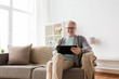 © Syda Productions - senior man with tablet pc sitting on sofa at home