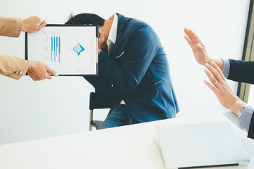 Wall Mural - Angry boss giving a document to a sad employee sitting in a desk at office