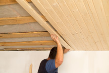 Worker Working On A Wooden Ceiling In The House