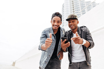 Wall Mural - Two young african men friends walking outdoors