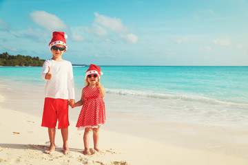 Wall Mural - kids celebrating christmas on tropical beach