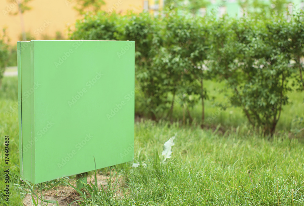 Empty sign board on lawn in park