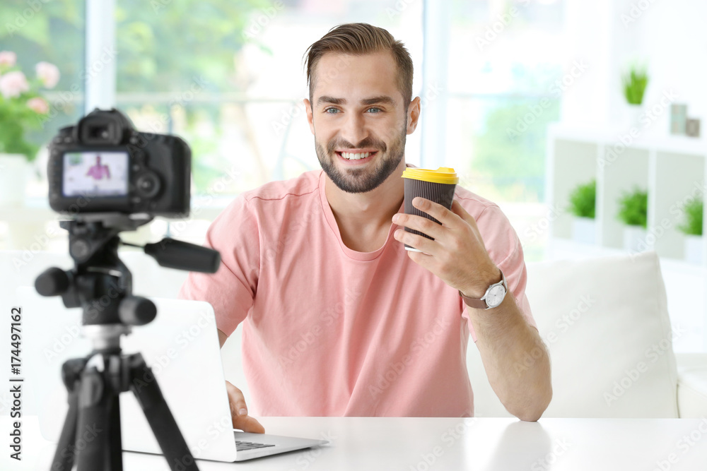 Young blogger recording video at home