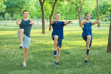 Poster - Young sporty men doing exercise outdoors