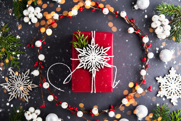 Wall Mural - frame with christmas gift on dark background top view. merry christmas greeting card. winter xmas ho
