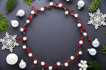 Wall Mural - frame with christmas wreath, white balls, berries, branches and snowflakes on dark background top vi