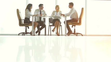 Wall Mural - The business partners talk at the table in a sunny background