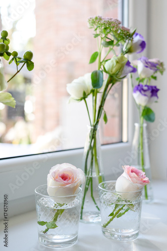 Fresh Tender Pink Garden Roses In Glass Vases On Window Sill