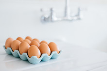 Brown Chicken Eggs Displayed On An Enamel Countertop