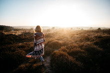 A Woman Walking In The Heath In Sunset Light