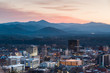 © Matthew Spaulding/Stocksy - View of Asheville city skyline and mountains after sunset