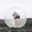 © Jovana Rikalo/Stocksy - Artistic photo of a couple standing in a big ballon