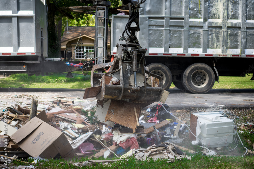 Large truck picking up trash and debris outside of neighborhoods ...