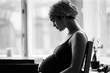 © Anna Malgina/Stocksy - A black and white film portrait of a young beautiful  pregnant woman