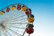 © AlejandroMCB photo & film/Stocksy - Detail of colourful ferriss wheel against blue sky