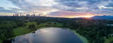 Fototapeta  - Aerial View of Deer Lake Park with Metrotown City Skyline in the backgournd. Taken in Burnaby, Greater Vancouver, British Columbia, Canada, during a cloudy sunset.