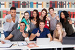 © Andrey Popov - College Students Gesturing Thumbs Up Sign Together