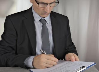 Business man signing  a contract making a deal, classic business concept