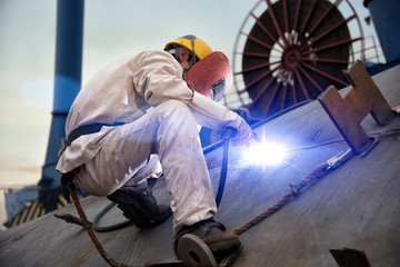 A welder at a shipyard