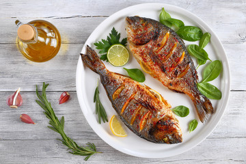 Wall Mural - roasted sea bream fish with lemon slices