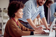 © chika_milan - Multi ethnic team working at modern office space