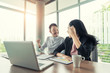 © Prasit Rodphan - Asian couple business people with casual suit working with happy action in office Business people concept.