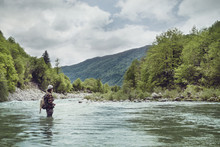 Slovenia, Man Fly Fishing In Soca River